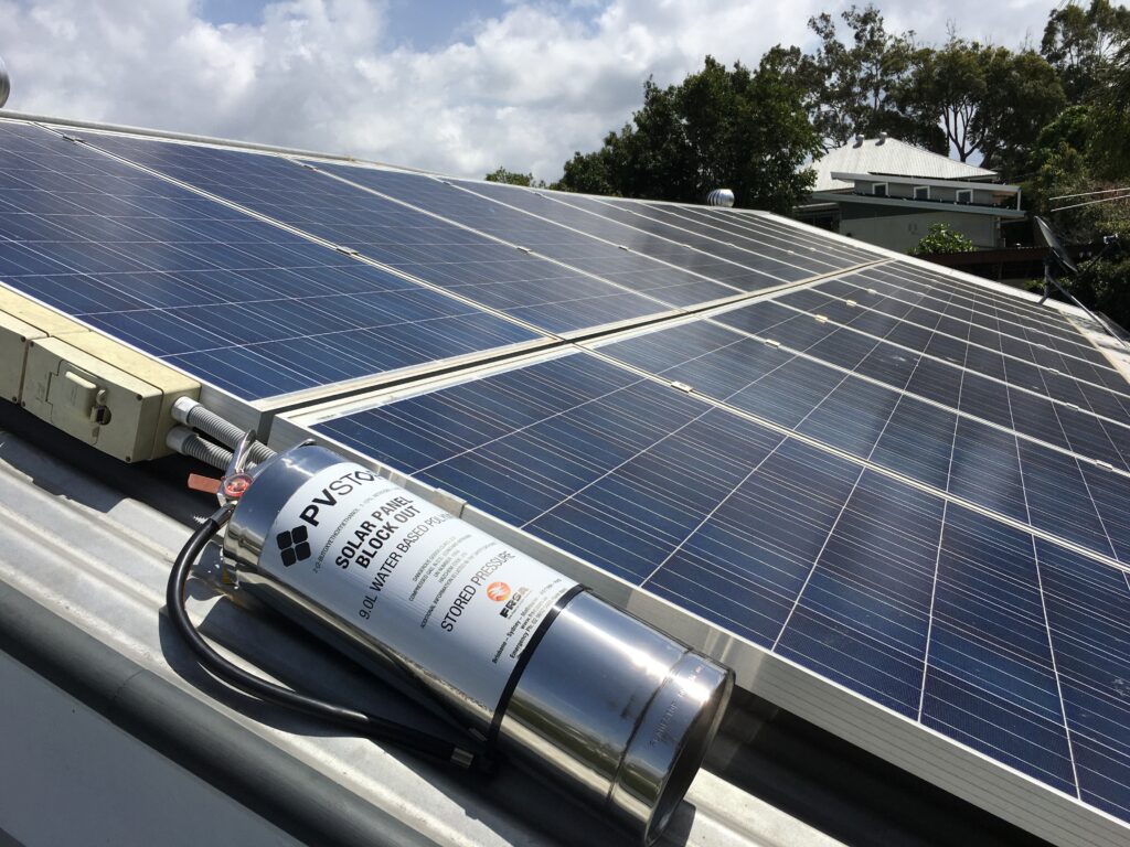 A PVStop canister ready for use alongside a large solar panel array